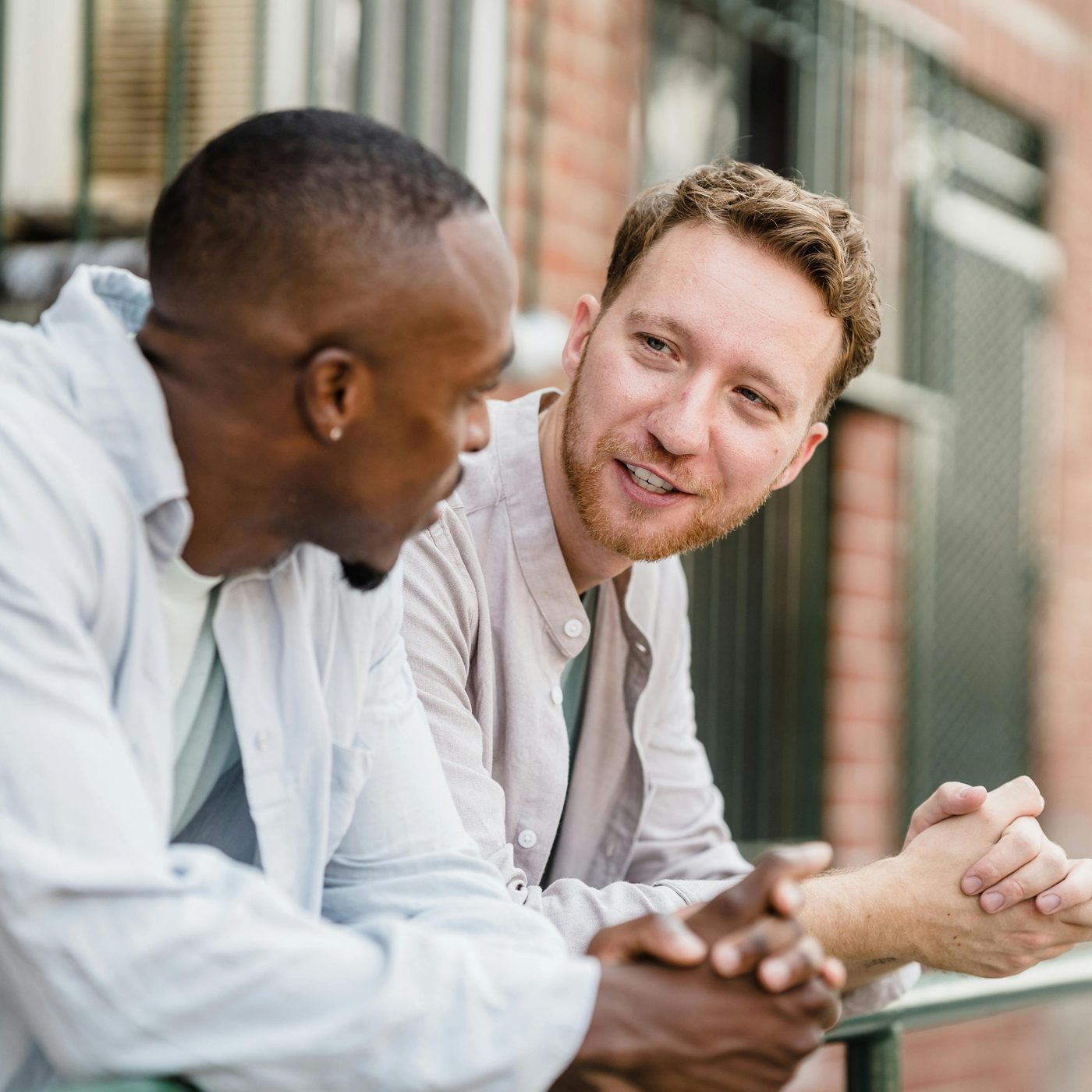 Two people having a casual conversation outdoors